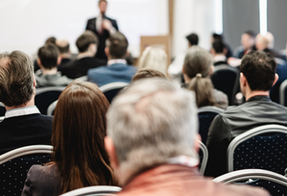 A crowd listens to a lecture
