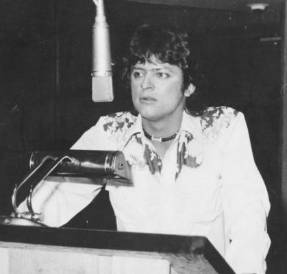 Johnny Rodriguez speaks into microphone