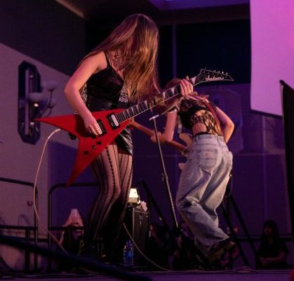 young women playing guitar